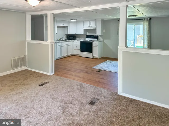 a kitchen with a sink cabinets and wooden floor