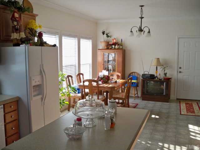 208 W Road Angier, NC 27501 - Photo 3 of 6 a dining room with furniture a chandelier and window