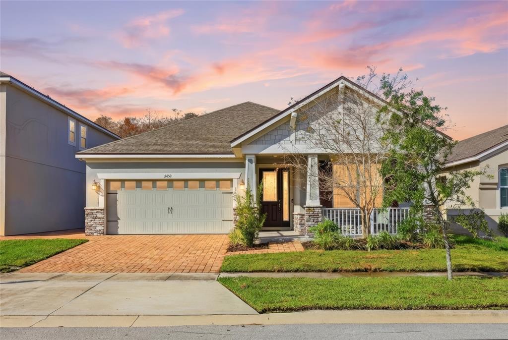 2452 Varenna Loop Kissimmee, FL 34741 - Photo 1 of 1 a front view of a house with a yard and garage