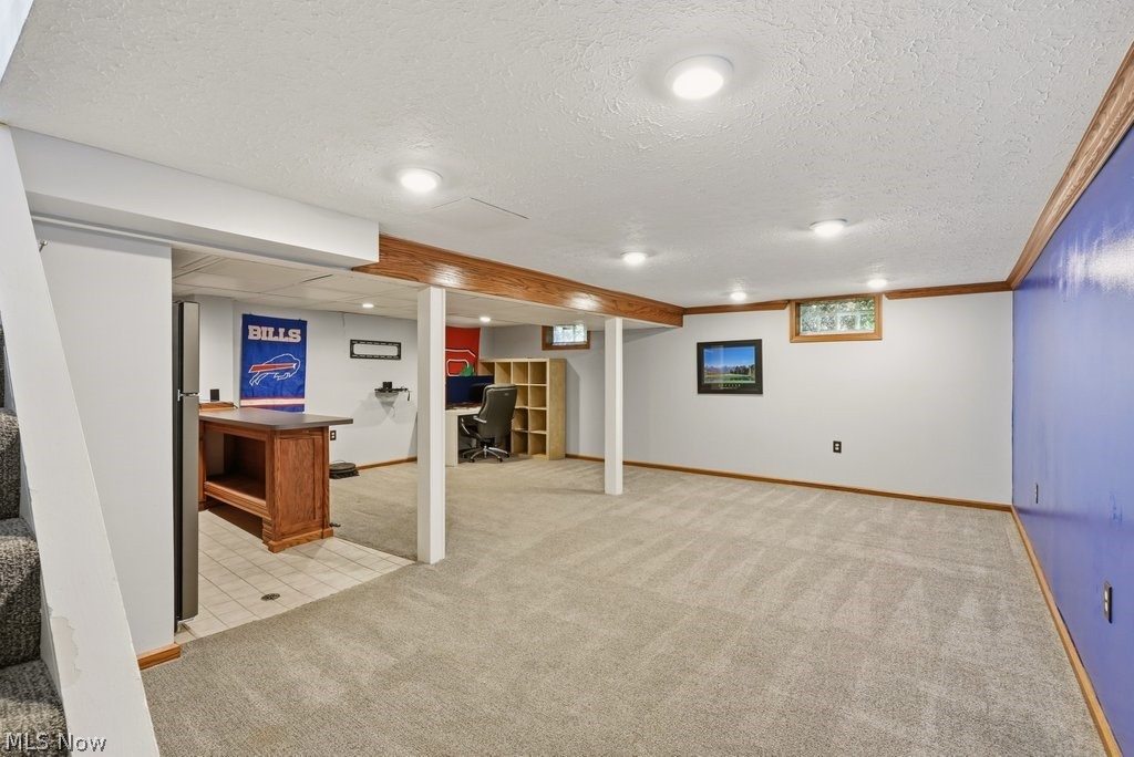 5321 Young Road Stow, OH 44224 - Photo 33 of 37 Finished lower level featuring recessed lighting, a wood-finish beam ceiling, window, and neutral carpeting