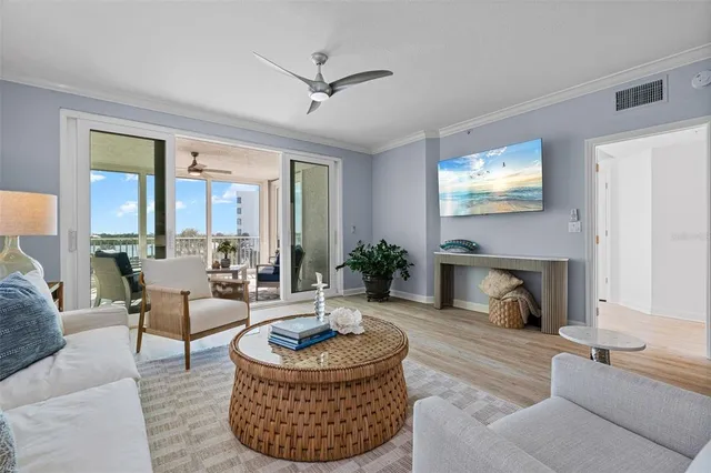 a living room with furniture a fireplace and a large window