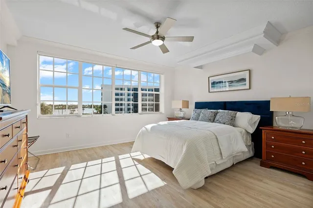 a bedroom with a large bed and a window
