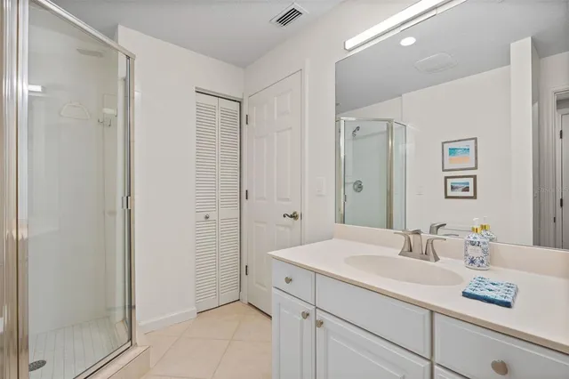 a bathroom with a sink shower and a mirror