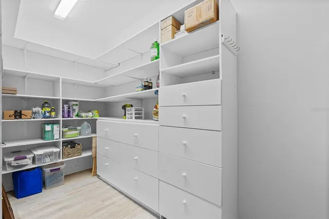 a view of walk in closet with empty racks