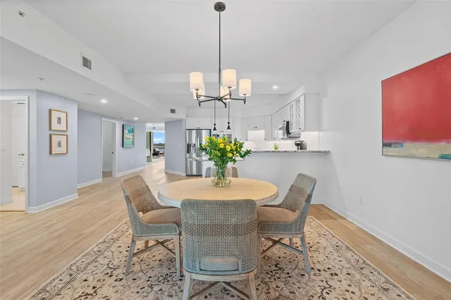 a dining room with furniture a rug and a chandelier