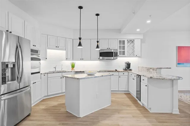 a kitchen with appliances a sink and cabinets