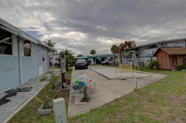 a view of a backyard with sitting area