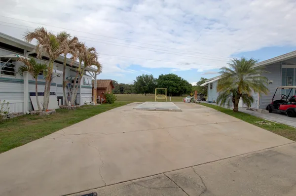 a view of a street with a building and a street sign