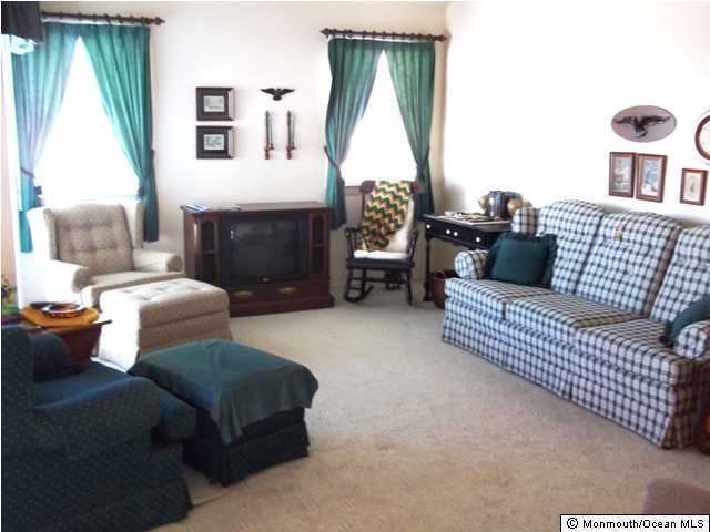185 Peter Road Manahawkin, NJ 08050 - Photo 1 of 3 a living room with furniture and a fireplace