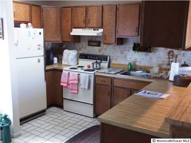 185 Peter Road Manahawkin, NJ 08050 - Photo 3 of 3 a kitchen with a refrigerator and a stove