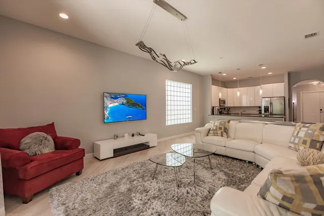 a living room with furniture and kitchen view