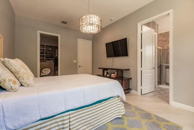 a bedroom with a bed and a flat screen tv