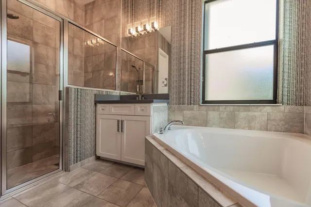 a bathroom with a bathtub and a shower