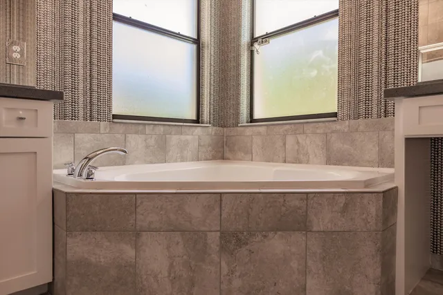 a bathroom with a bathtub and a window