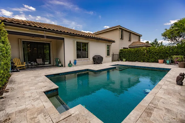 a view of a house with swimming pool with a yard and furniture