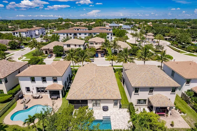 an aerial view of multiple houses with a yard