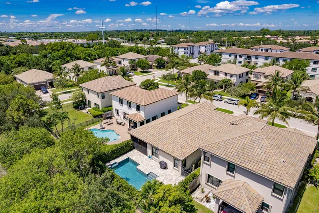 an aerial view of a house with a yard and lake view