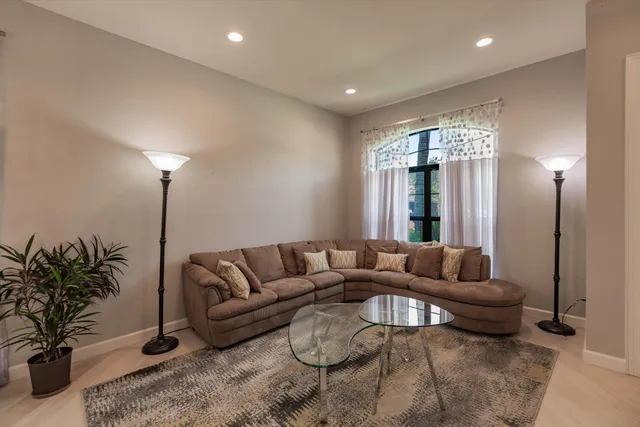 a living room with furniture and a potted plant