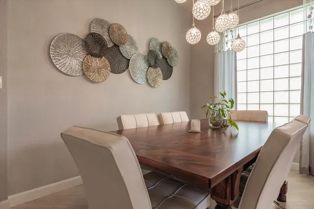a view of a dining room with furniture and chandelier