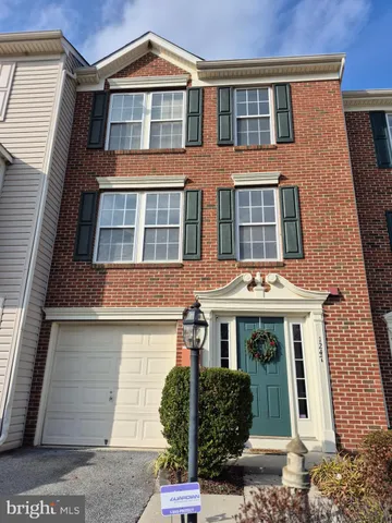 a front view of a residential apartment building with a yard