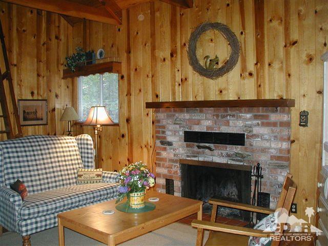 55290 Circle Way Idyllwild, CA 92549 - Photo 4 of 11 a living room with a fireplace a clock and a fireplace