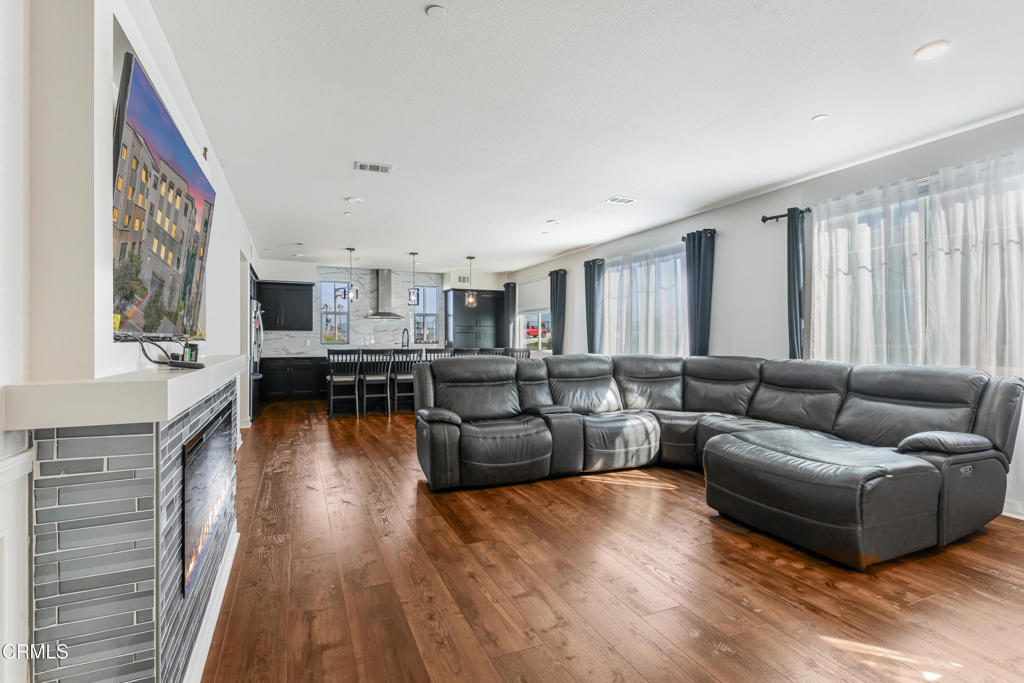 a living room with fireplace furniture and a wooden floor