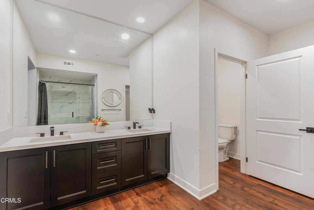 2820 Wagon Wheel Road, Unit 302 Oxnard, CA 93036 - Photo 12 of 26 a bathroom with a double vanity sink and mirror