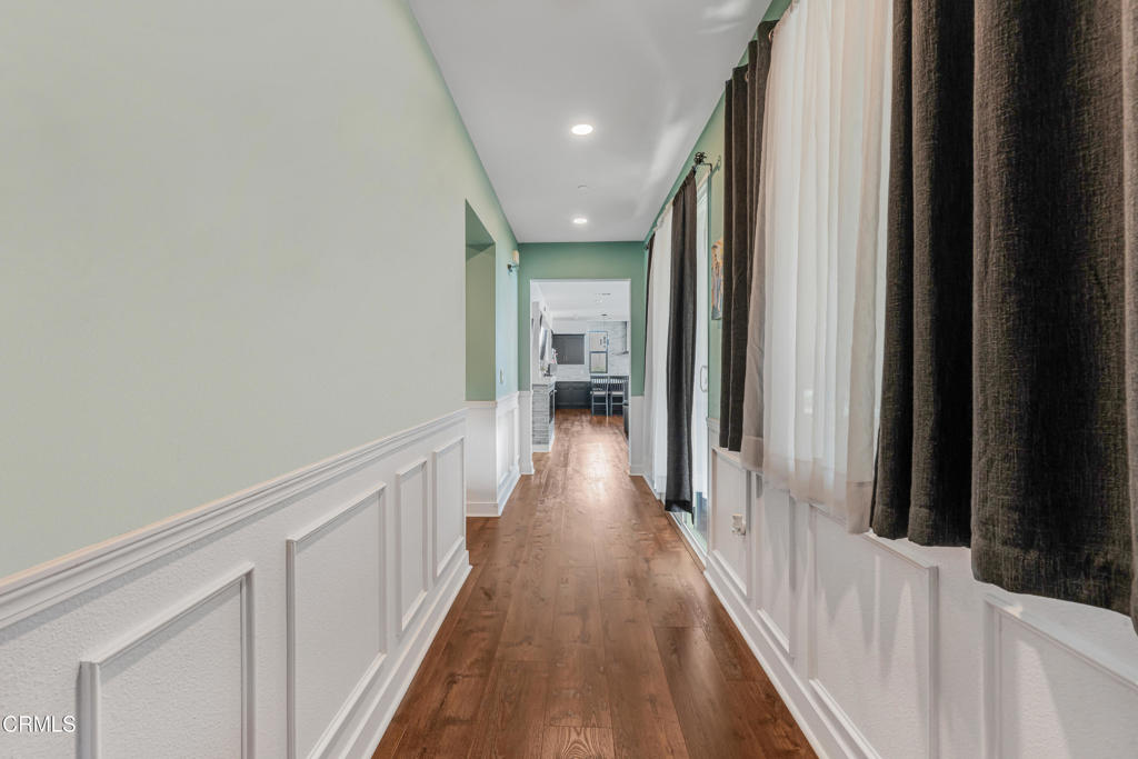 2820 Wagon Wheel Road, Unit 302 Oxnard, CA 93036 - Photo 14 of 26 a view of a hallway with wooden floor and staircase