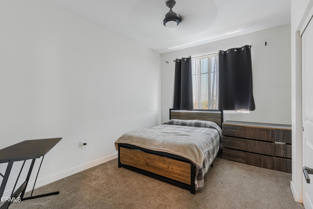 2820 Wagon Wheel Road, Unit 302 Oxnard, CA 93036 - Photo 15 of 26 a bedroom with a bed and a dresser