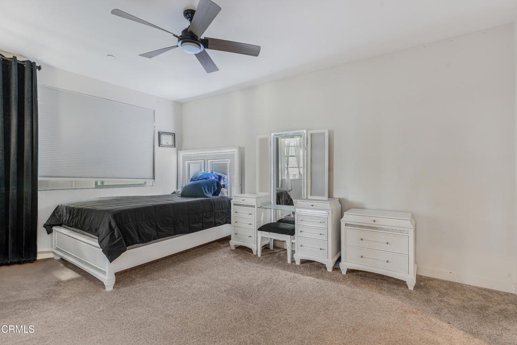 2820 Wagon Wheel Road, Unit 302 Oxnard, CA 93036 - Photo 9 of 26 a bedroom with a bed and a chandelier