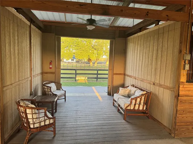a living room with furniture and a floor to ceiling window