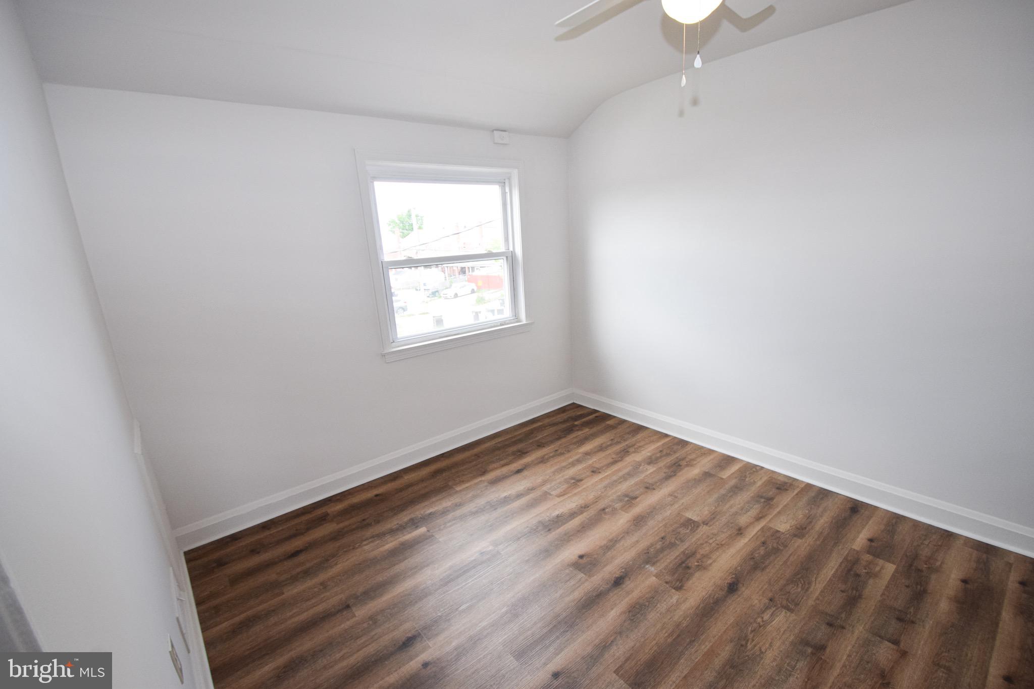 1922 Armco Way Dundalk, MD 21222 - Photo 12 of 26 an empty room with wooden floor and windows