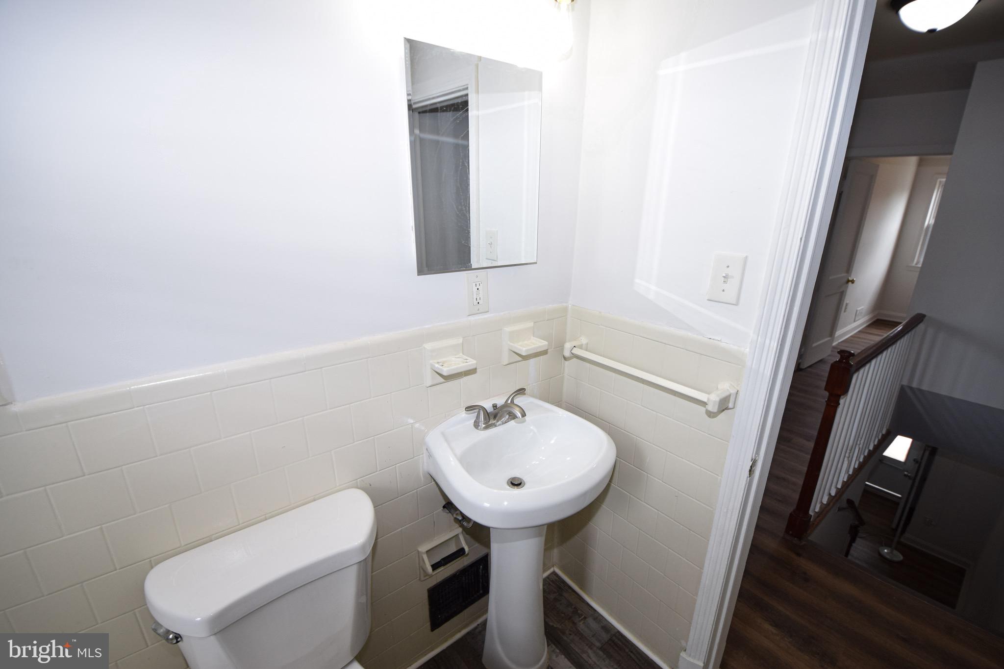 1922 Armco Way Dundalk, MD 21222 - Photo 15 of 26 a bathroom with a sink toilet and a mirror