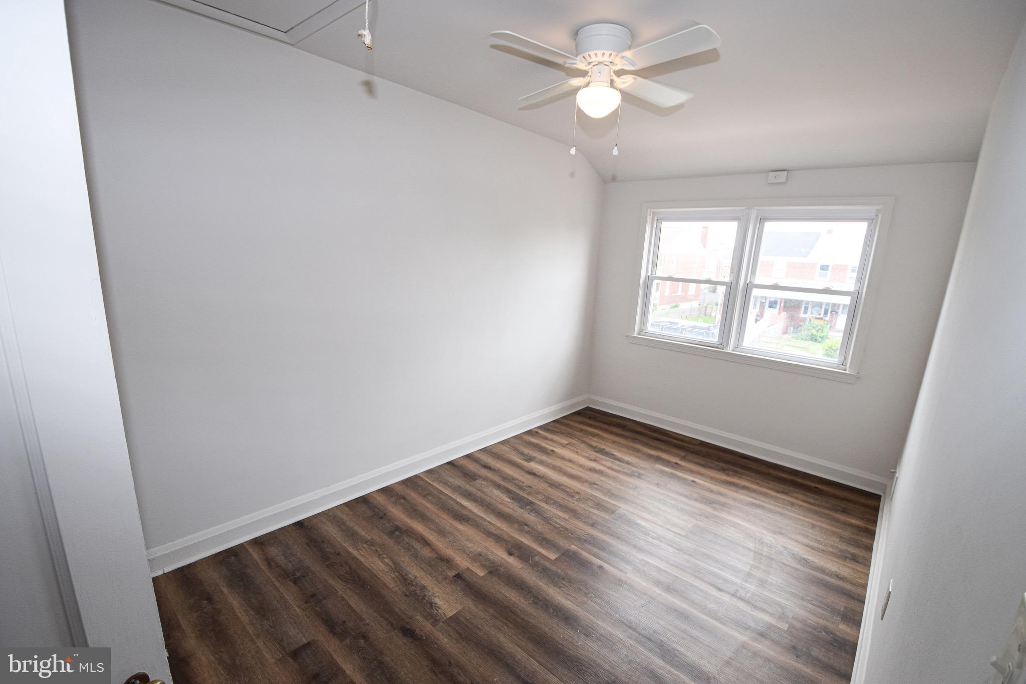 1922 Armco Way Dundalk, MD 21222 - Photo 16 of 26 wooden floor in an empty room with a window