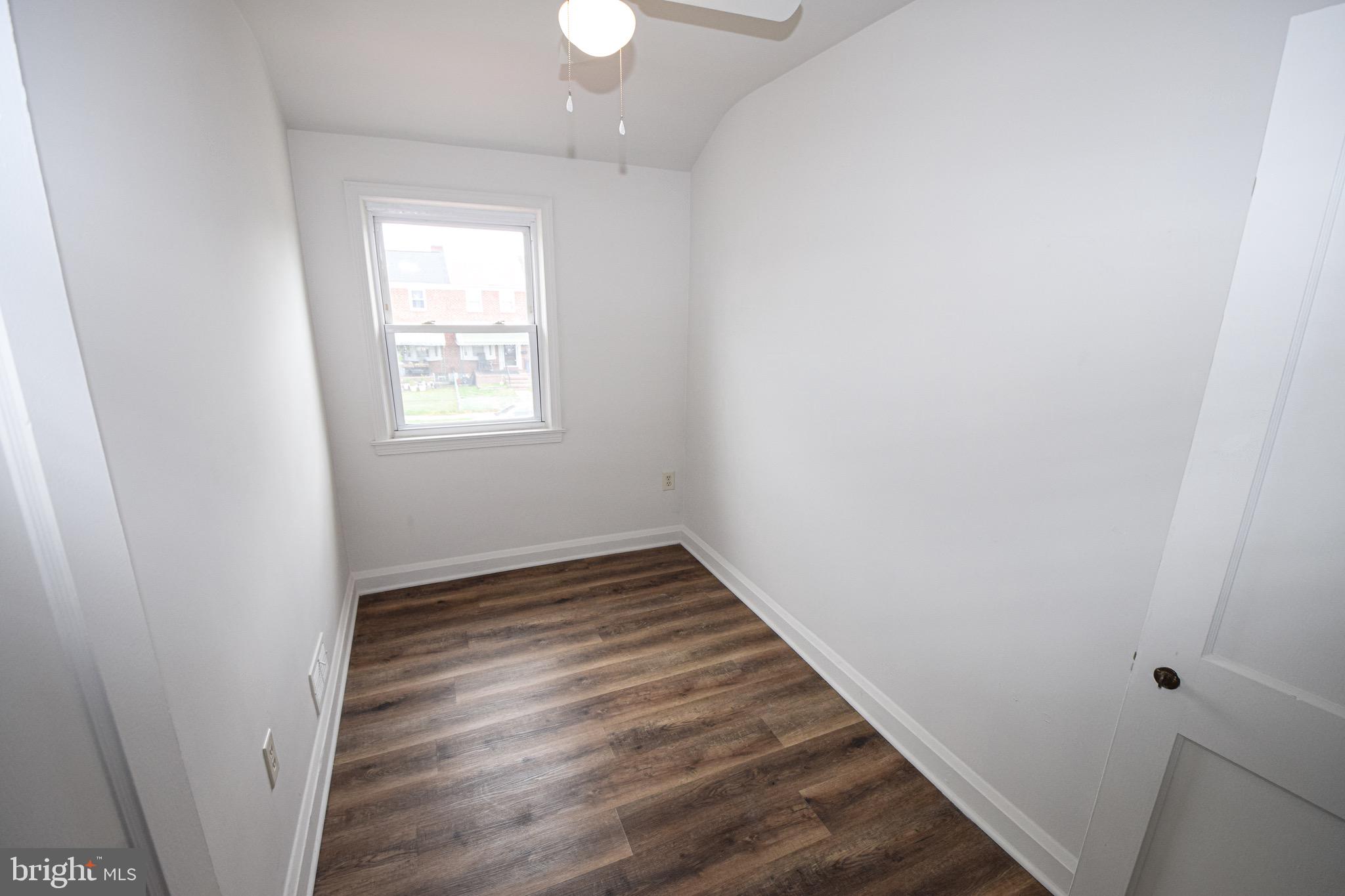 1922 Armco Way Dundalk, MD 21222 - Photo 18 of 26 an empty room with wooden floor and windows