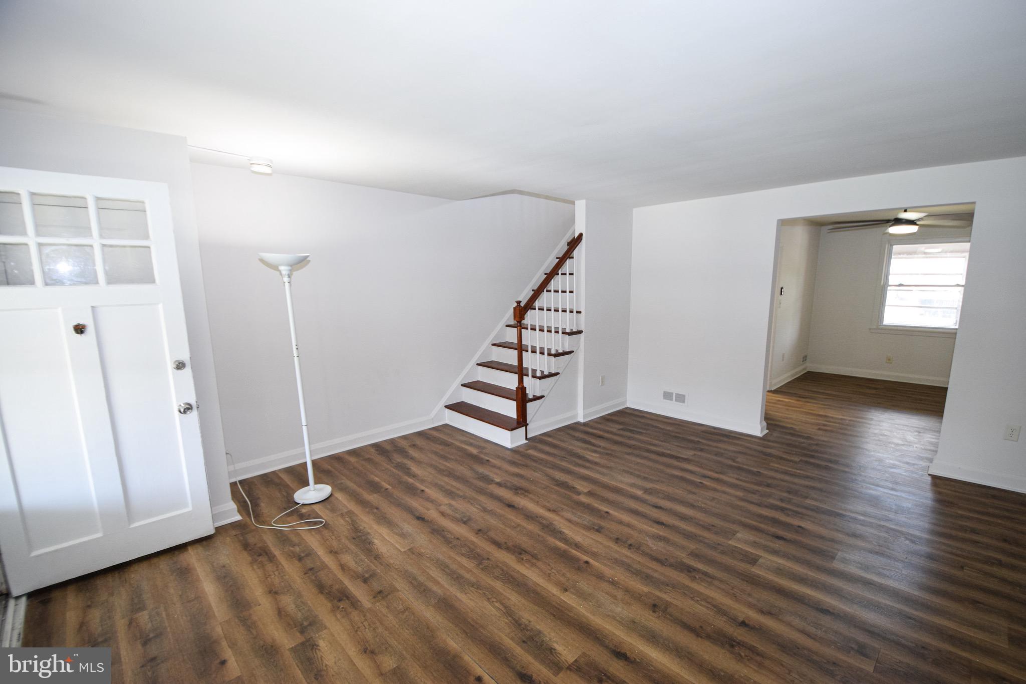 1922 Armco Way Dundalk, MD 21222 - Photo 2 of 26 an empty room with wooden floor and windows
