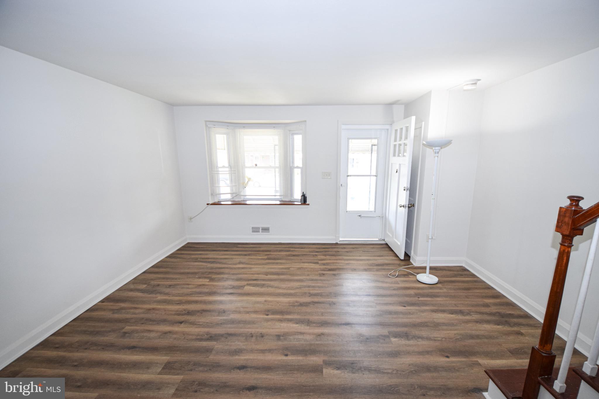 1922 Armco Way Dundalk, MD 21222 - Photo 4 of 26 a view of empty room with wooden floor and fan
