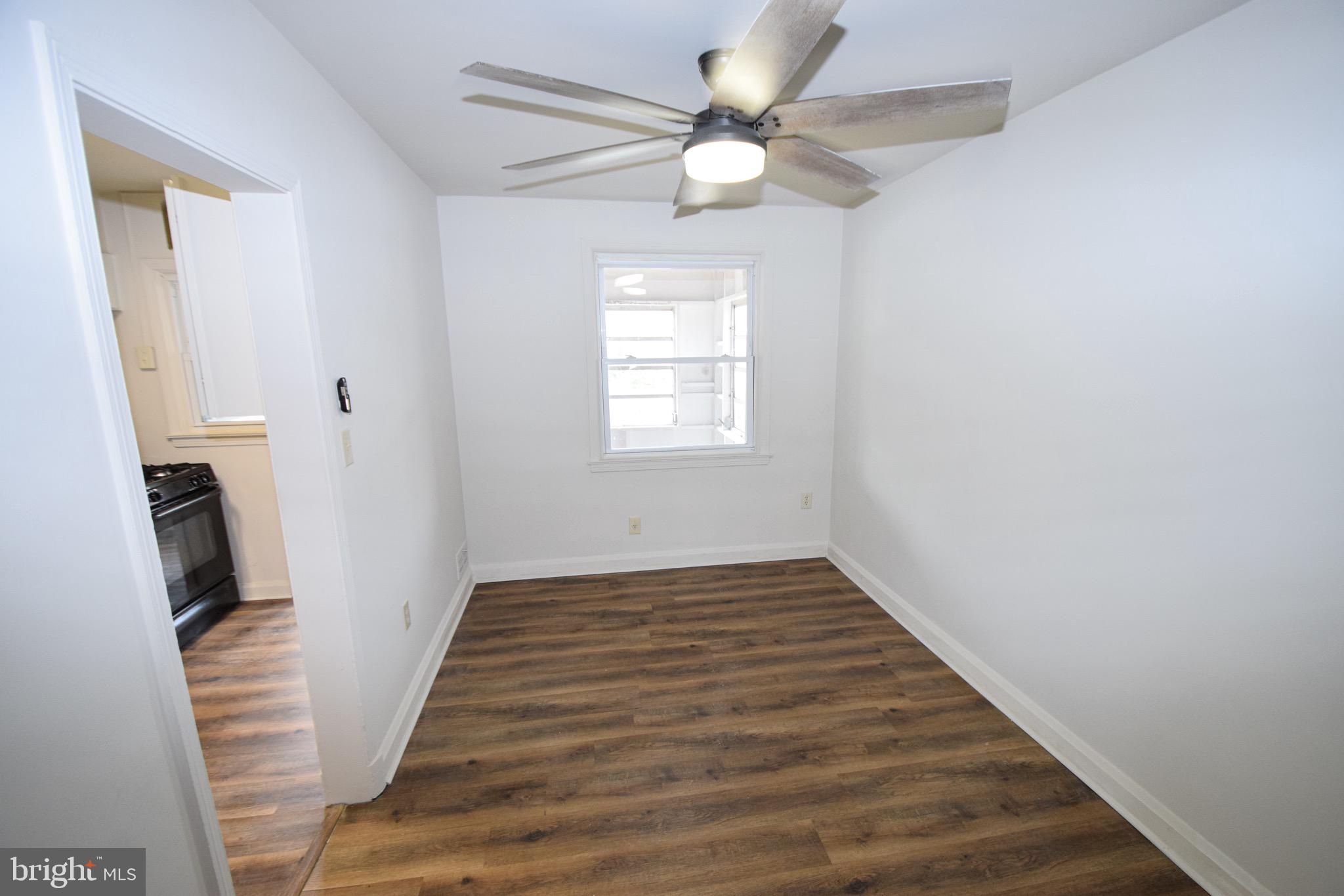 1922 Armco Way Dundalk, MD 21222 - Photo 5 of 26 a view of an empty room with wooden floor and fan