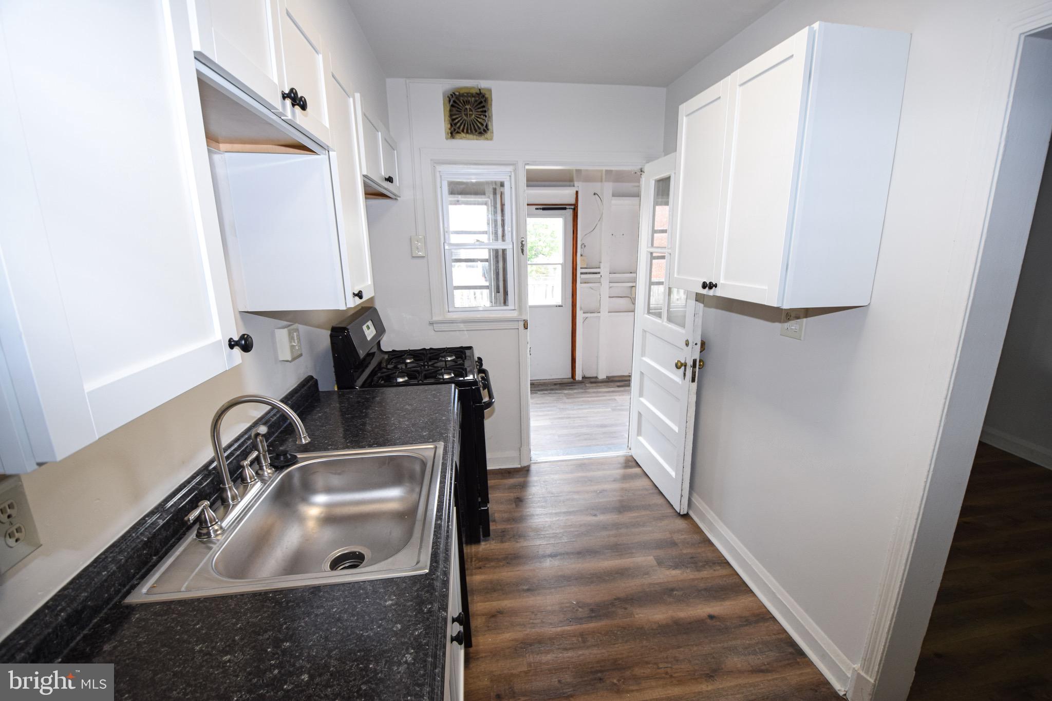 1922 Armco Way Dundalk, MD 21222 - Photo 8 of 26 a view of a kitchen with sink dishwasher and wooden floor