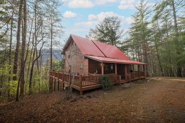 a view of a house with a yard and wooden fence