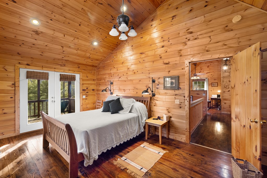 148 Dream Cove Road Cherry Log, GA 30522 - Photo 14 of 29 a bedroom with a bed and wooden floor