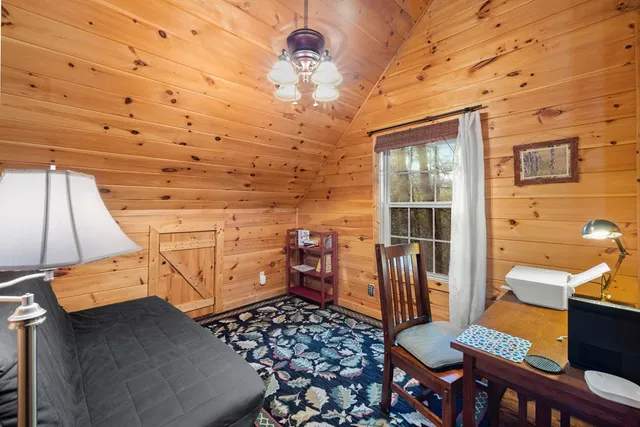 a view of a patio with table and chairs with wooden floor and fence