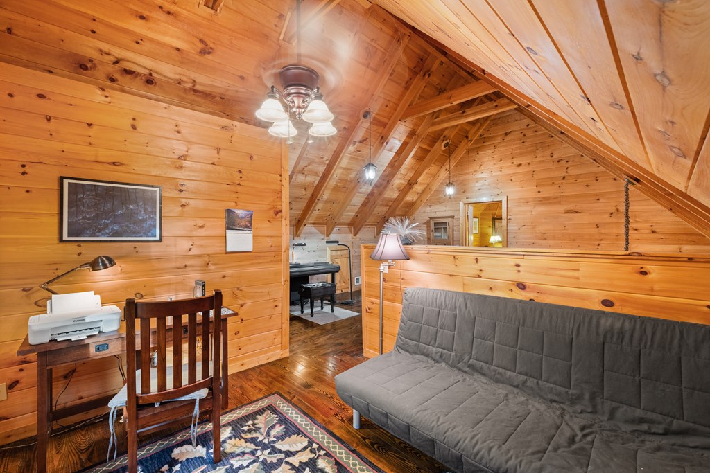 148 Dream Cove Road Cherry Log, GA 30522 - Photo 18 of 29 a view of a patio with table and chairs with wooden floor and fence
