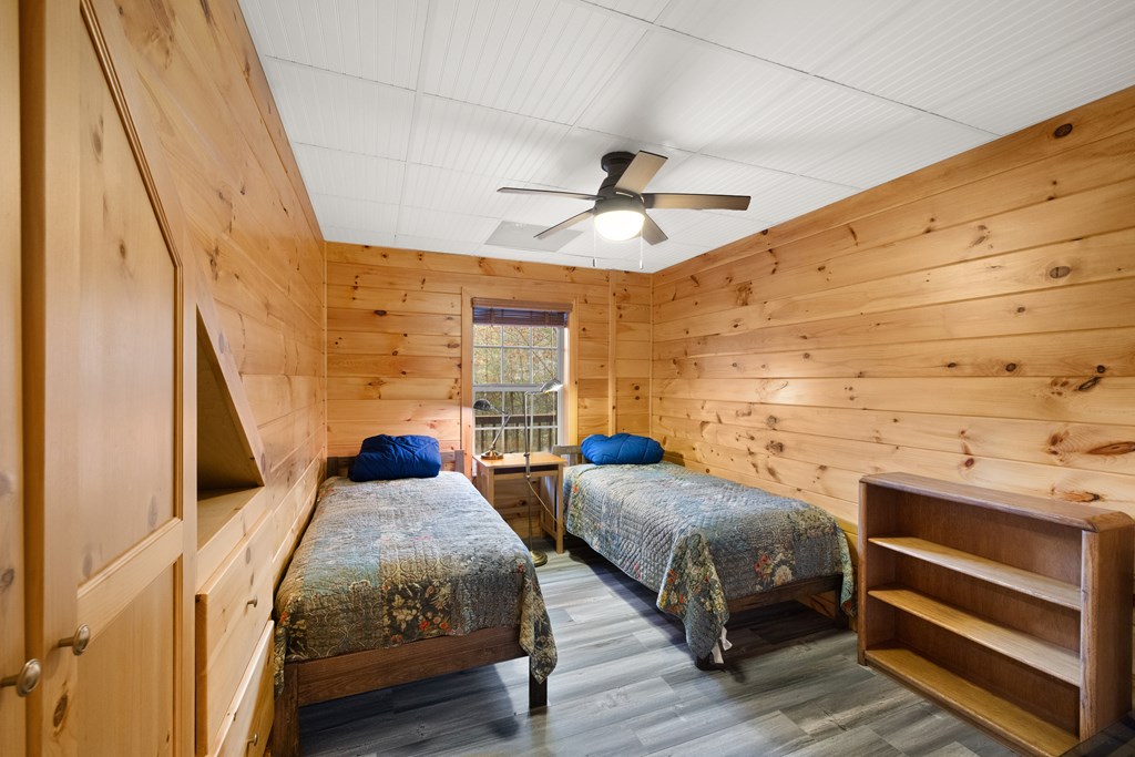 148 Dream Cove Road Cherry Log, GA 30522 - Photo 21 of 29 a bedroom with two beds and a ceiling fan