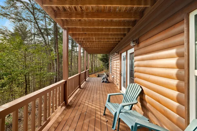 a view of a house with a yard and wooden fence
