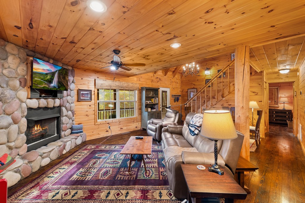 148 Dream Cove Road Cherry Log, GA 30522 - Photo 5 of 29 a living room with furniture a flat screen tv and a fireplace