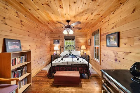 a living room with furniture and a book shelf