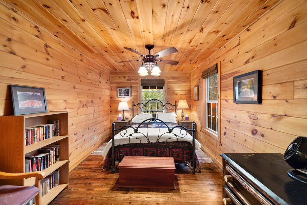 148 Dream Cove Road Cherry Log, GA 30522 - Photo 7 of 29 a living room with furniture and a book shelf