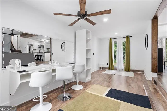 a living room with patio furniture and a wooden floor