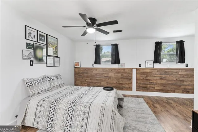 a bedroom with a large bed and a chandelier